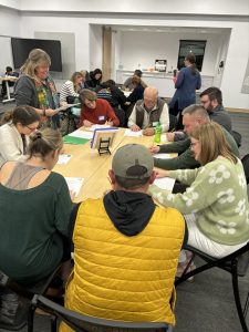A diverse group of adults engaged in a collaborative educational workshop